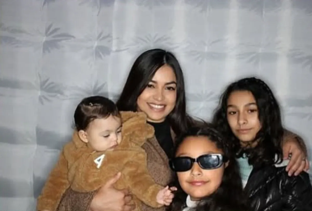 A family posing in the photo booth, holding their baby